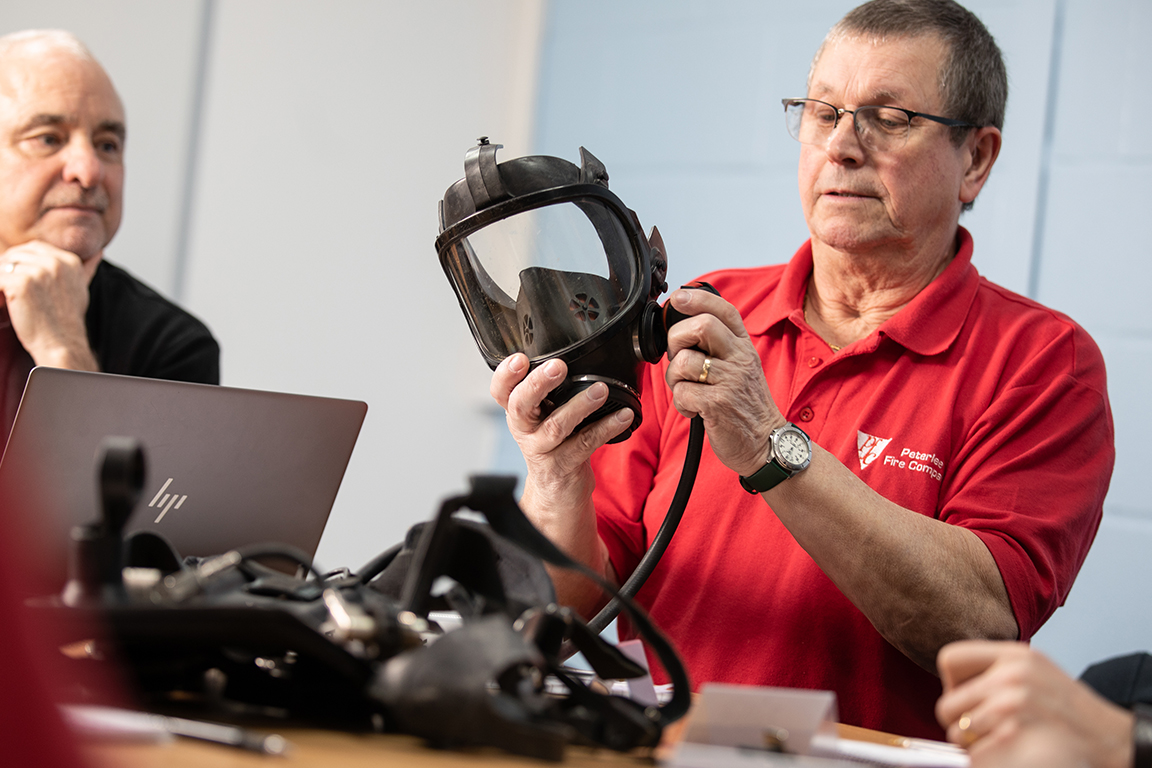 Gas mask being inspected in meeting